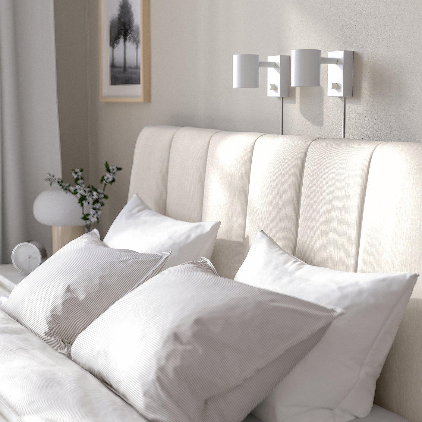 Bed with beige striped headboard, two wall-mounted lights, white pillows, and vase with greenery.