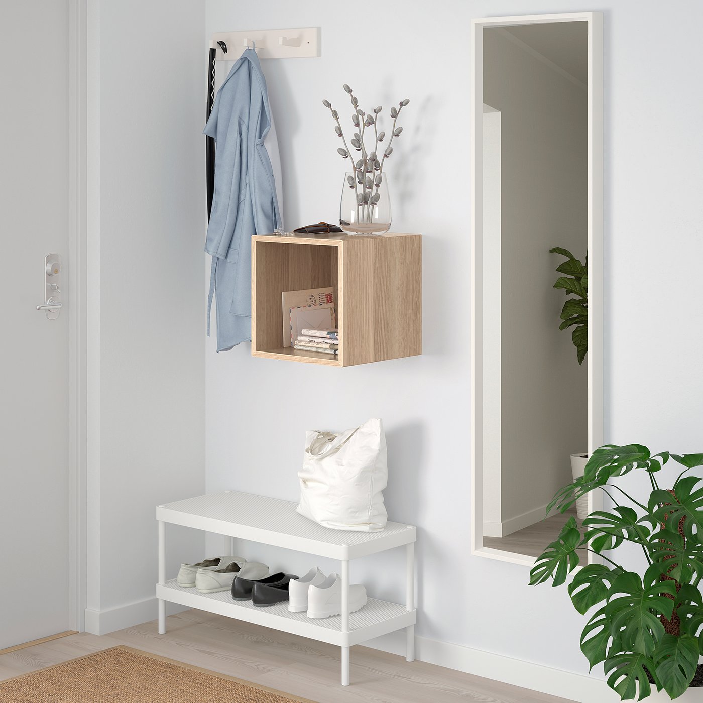 Minimalist entryway with EKET storage, mirror, and plant