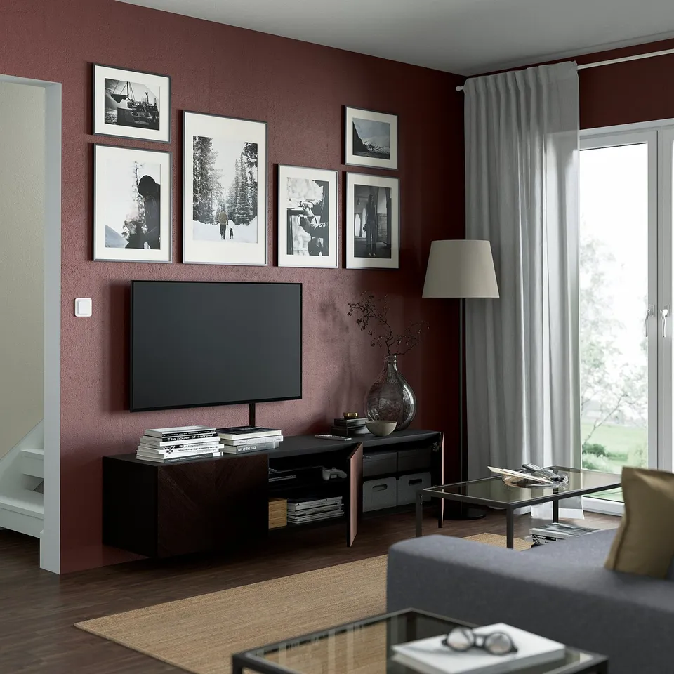 Modern living room with wall-mounted tv bench, shelves, and cable management. Lamp and decor beside tv, curtains open.