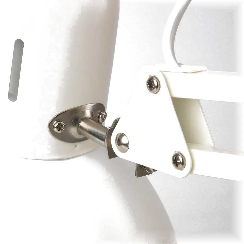 Close-up of white TERTIAL lamps sturdy metal hinge and adjustment screws.
