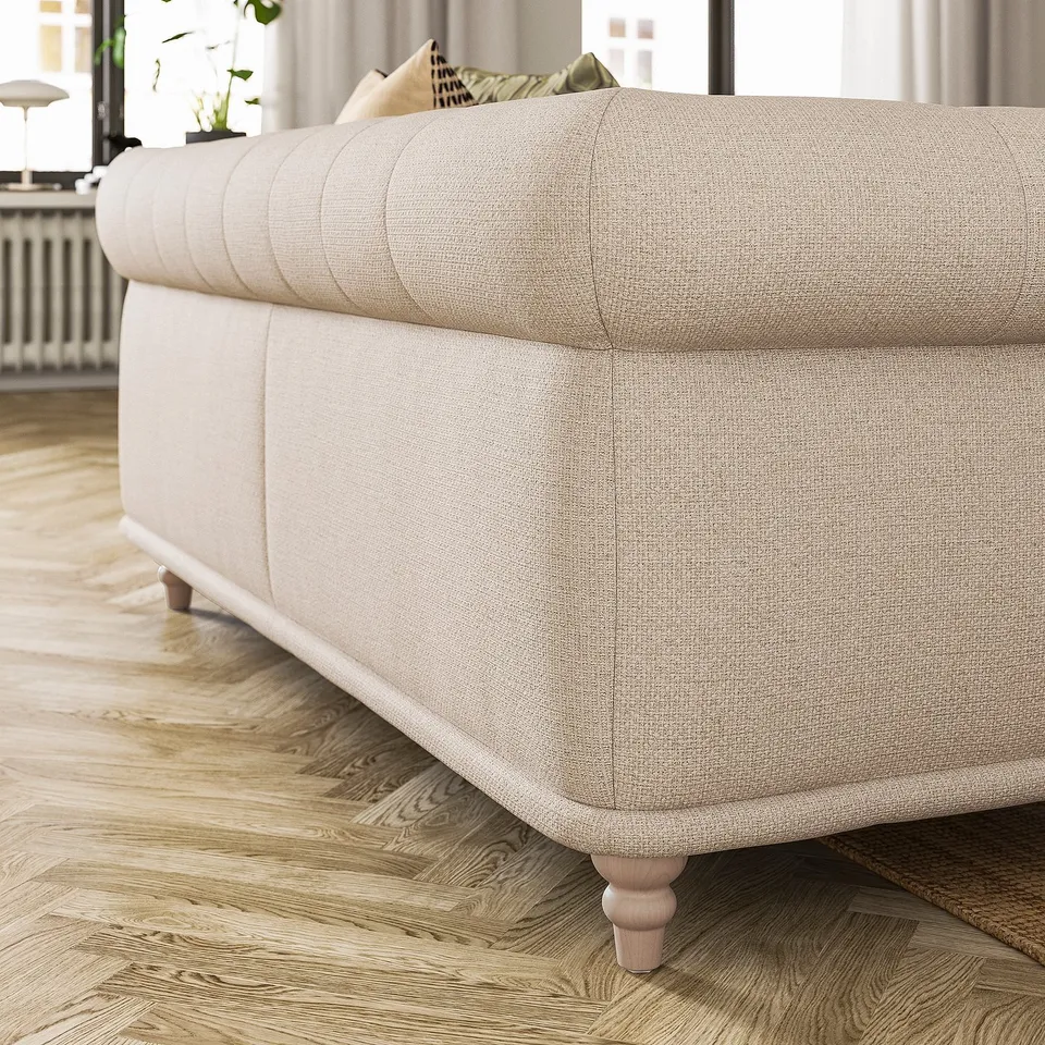 Off-white VISKAFORS sofa with rounded, tufted back and depth, on wooden floor. Traditional design, inviting shape.