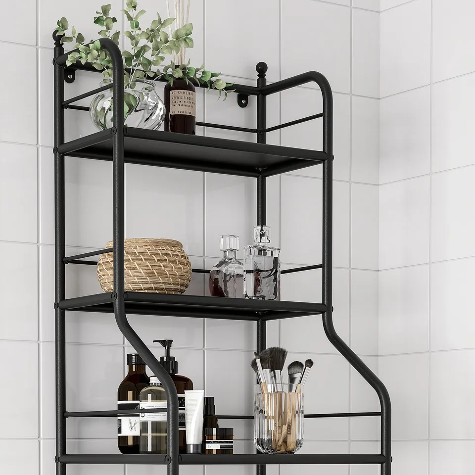 Black metal bathroom shelf, three tiers with towels, bottles, and toiletries.