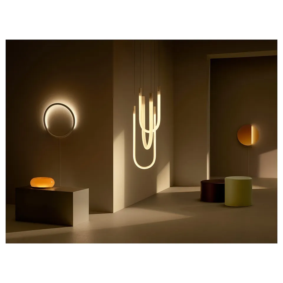 Modern room with warm lighting and VARMBLIXT lamps in minimalist design.