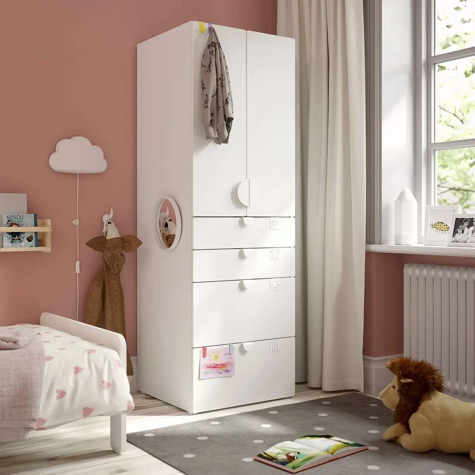 Kids room with SMÅSTAD wardrobe, heart bed, toys, and polka dot rug.
