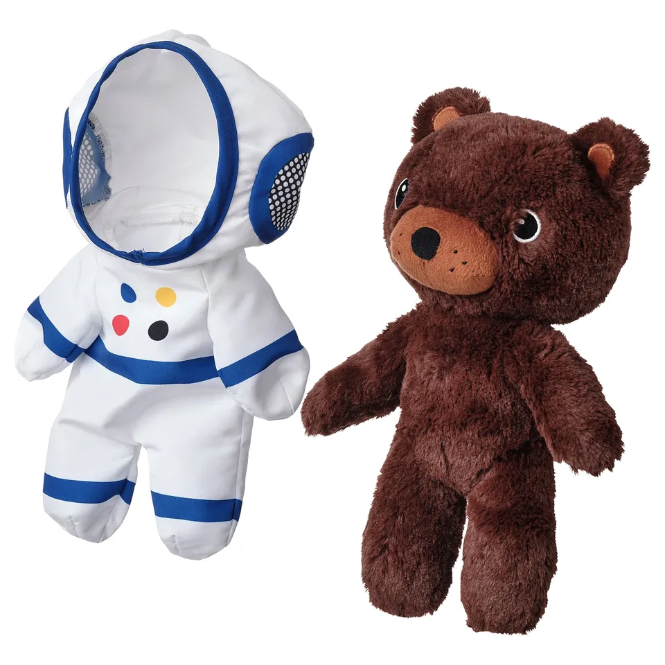Brown bear & white astronaut toys, space-themed, holding hands