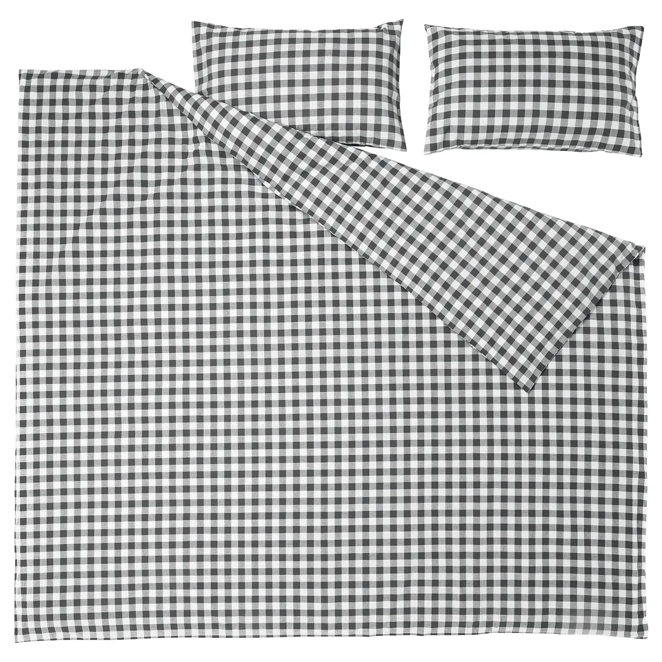 A set of black and white gingham bedding, including a duvet cover and pillowcases, made from 100% organic cotton.