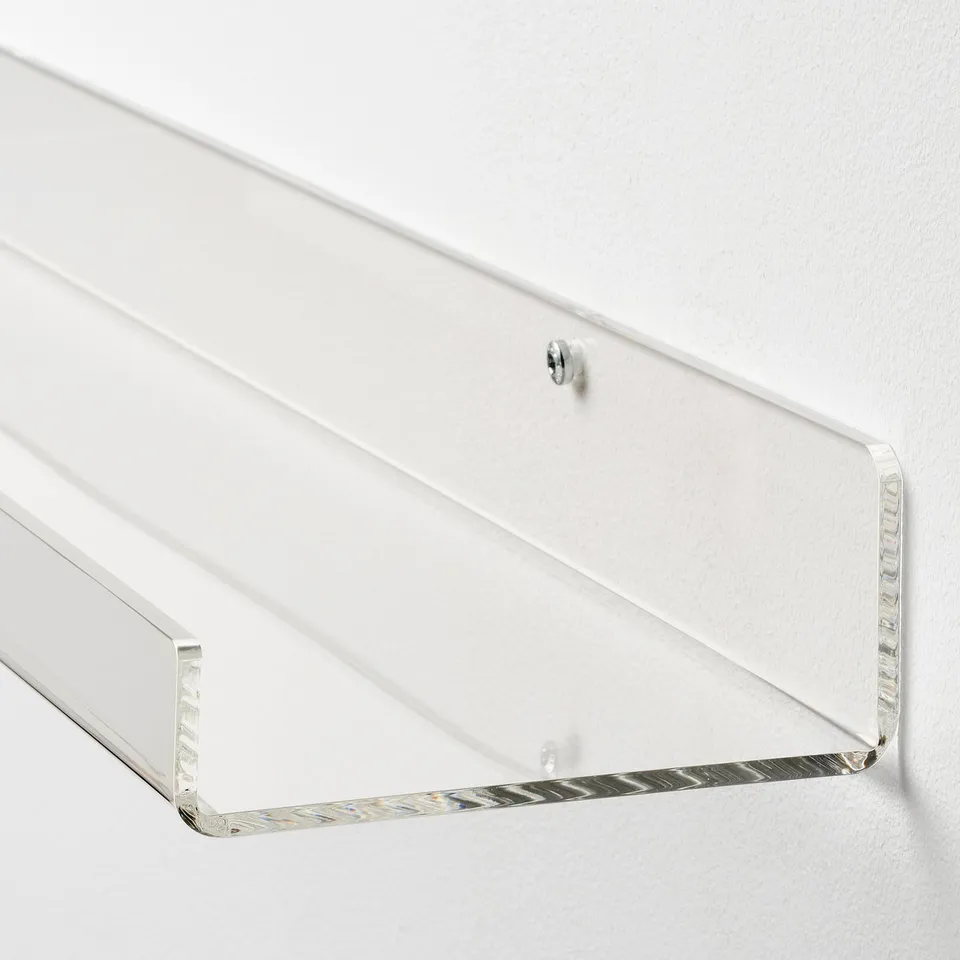 Acrylic wall shelf on white wall, minimalist design.