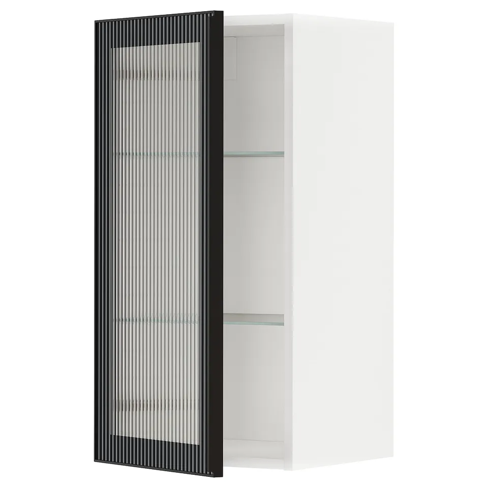 Modern white METOD kitchen cabinet with black, ribbed glass door.