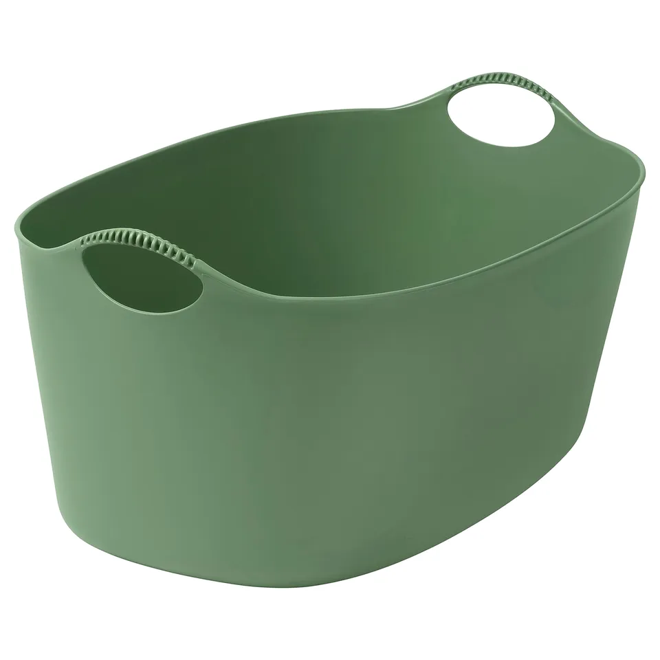 Green flexible TORKIS laundry basket with two handles.