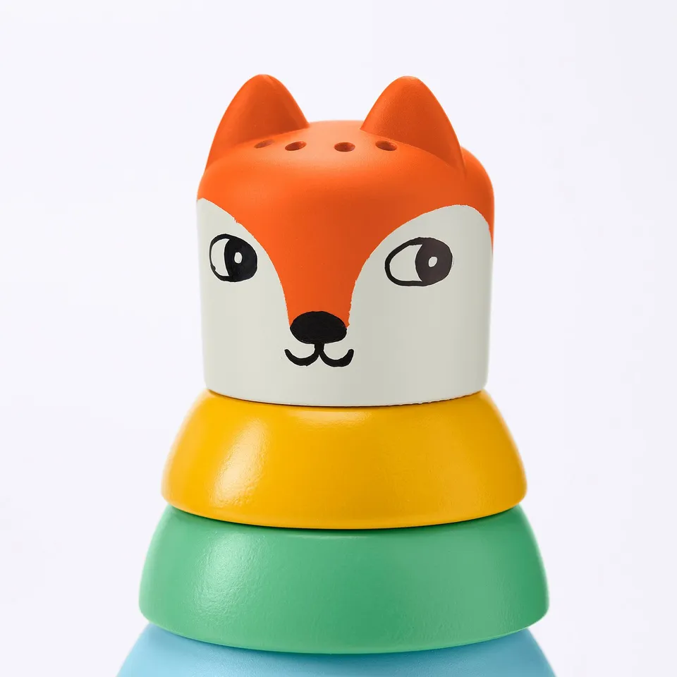 Stacking toy with colourful rings; top ring shaped like orange and white fox head.