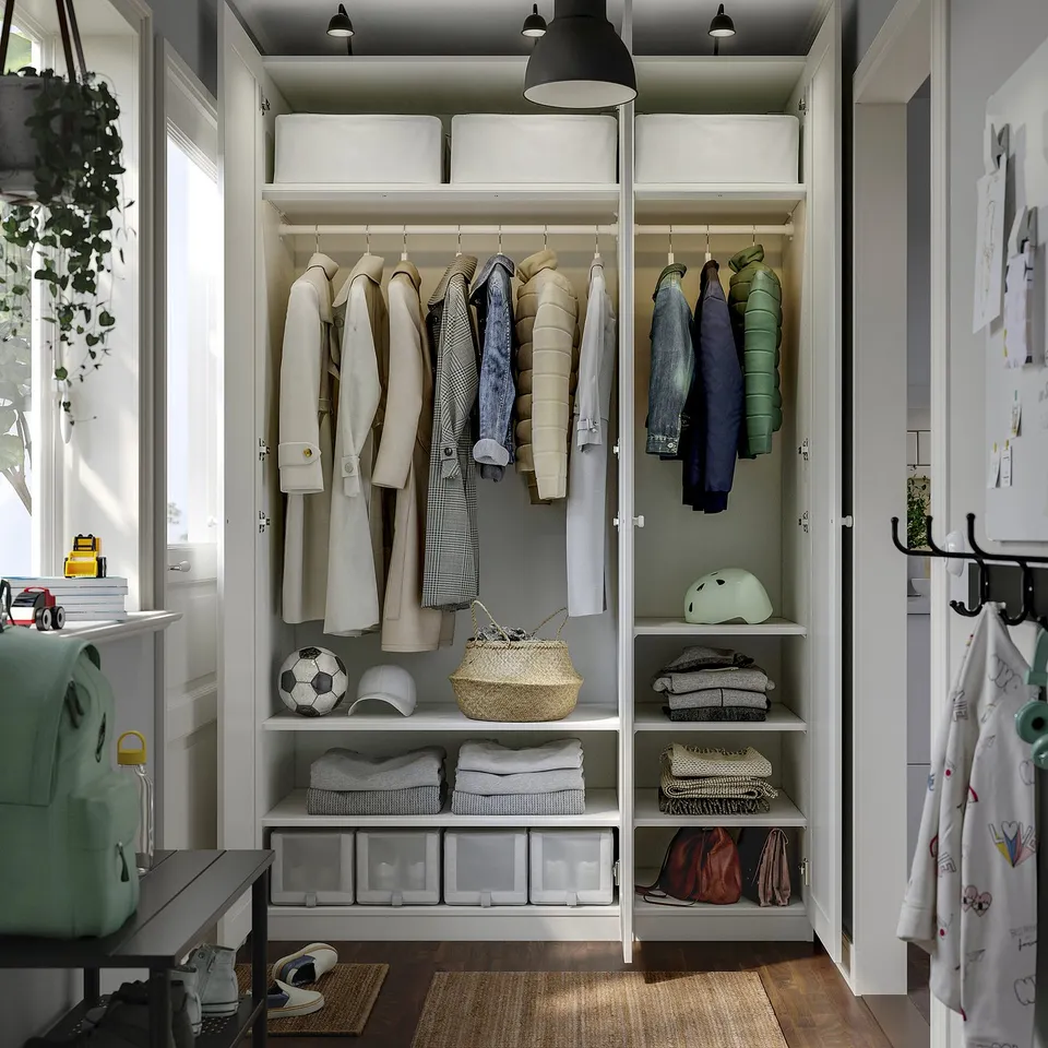 Organised closet with coats, folded clothes, and stored items. Adjustable feet and integrated lighting with dampers.