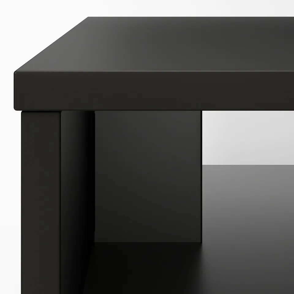 Black coffee table with metal frame and foil top, clean lines, durable and elegant.