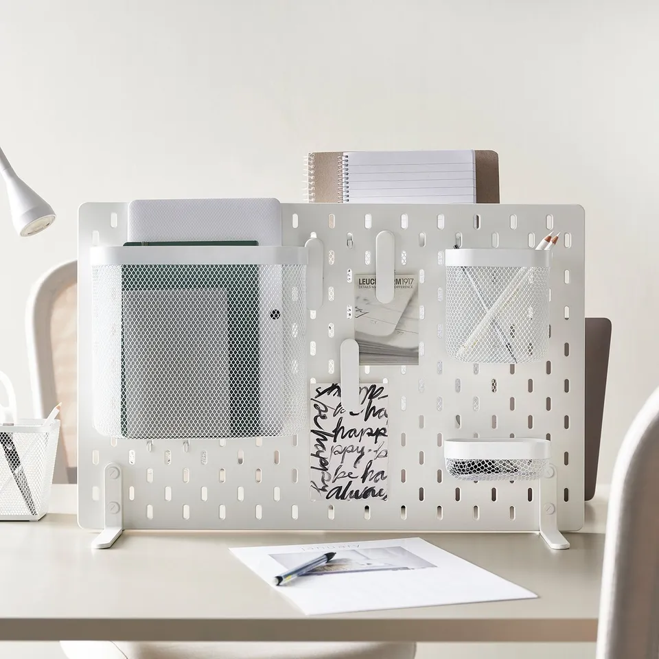 SKÅDIS divider on desk organises office supplies.
