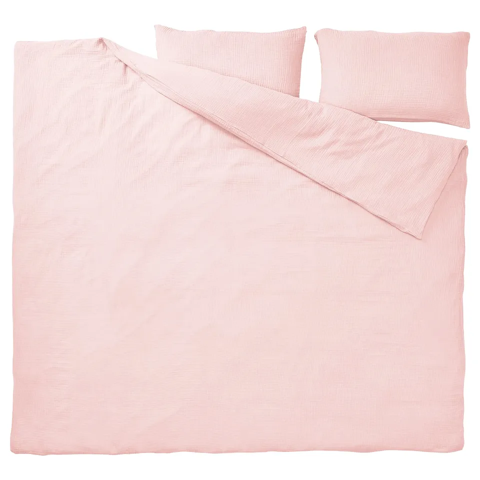 A SCHERSMIN bedding set in light pink, featuring a duvet cover and pillowcases, made of 100% organic cotton.