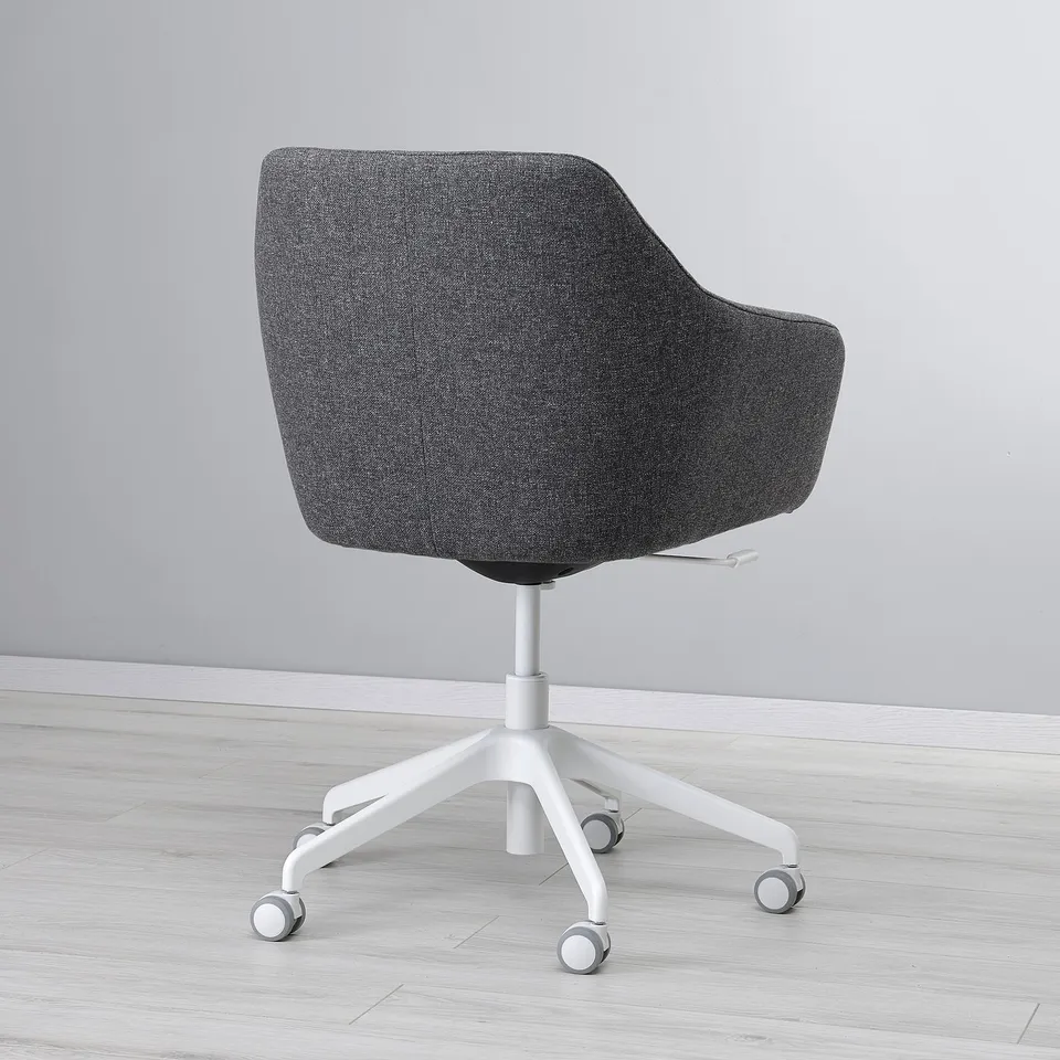 Modern office chair, dark grey fabric, padded, five castors, white base.
