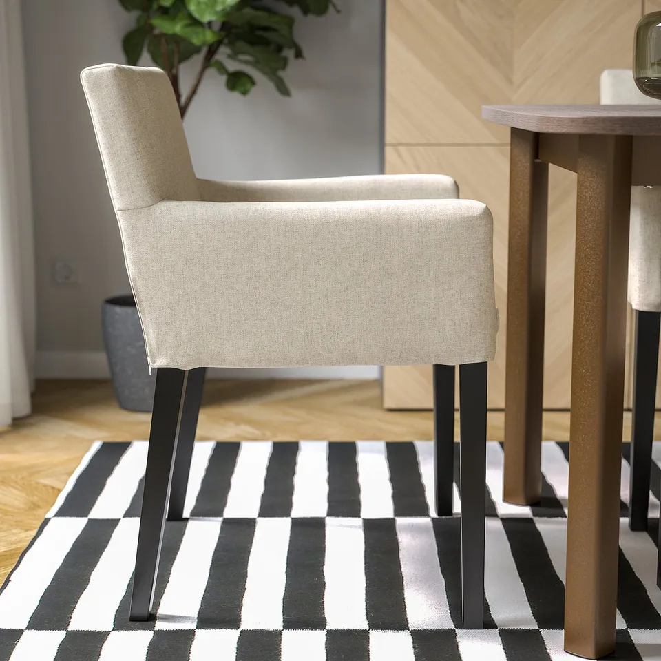 Chair with padded seat and armrests on striped rug, perfect for comfortable dining.
