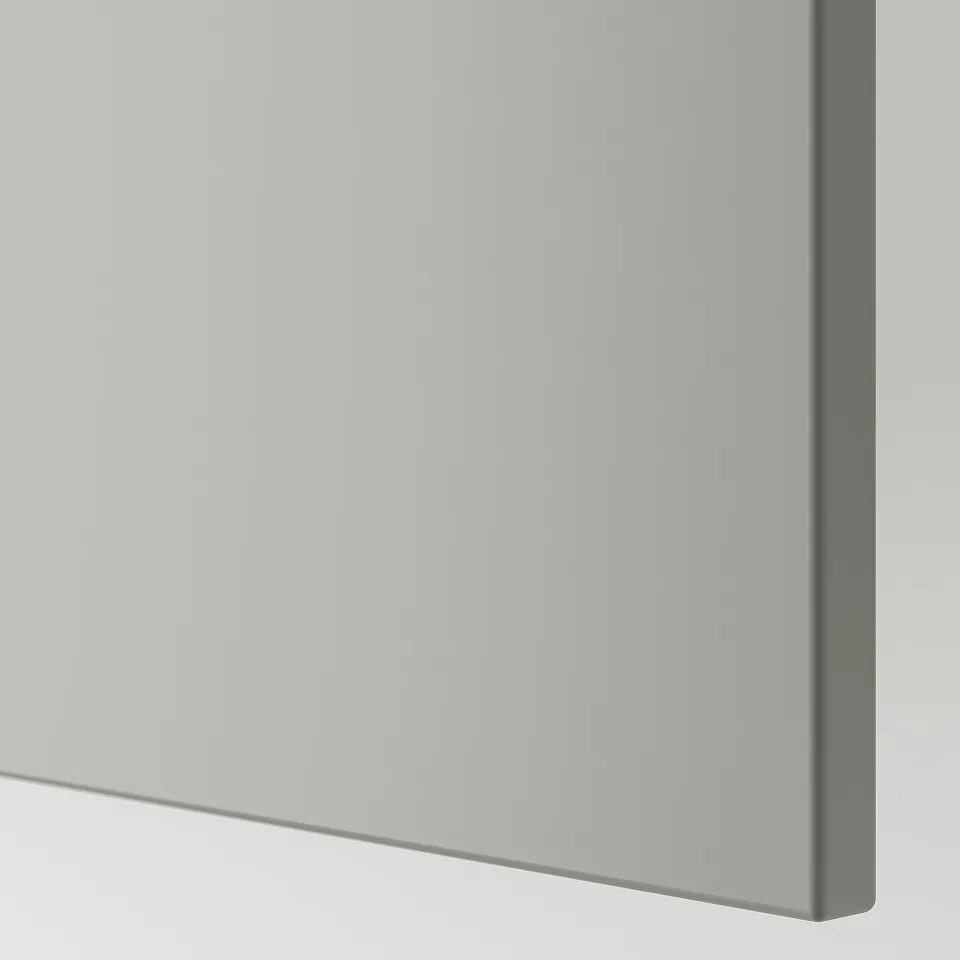 A close-up of a smooth, neatly finished kitchen cabinet panel. The light grey colour and clean lines suggest high quality and durability.