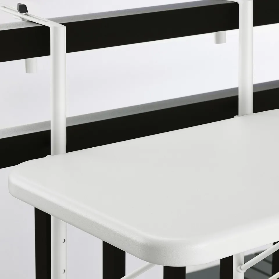 Foldable white outdoor table with black accents, made of durable powder-coated steel. Ideal for compact spaces.
