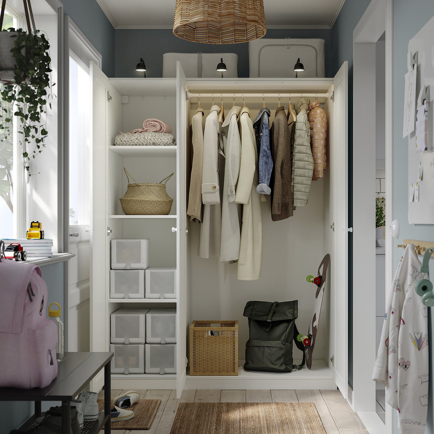 An open storage closet with hanging clothes and baskets, featuring adjustable feet, integrated lighting, and a stackable drawer system.