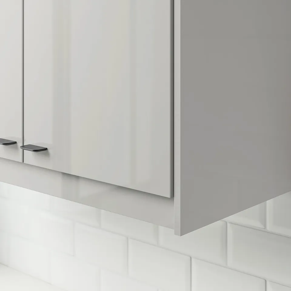 Modern grey high-gloss cabinet fronts with sleek handles, reflecting light, adding spacious feel to minimalist kitchen.
