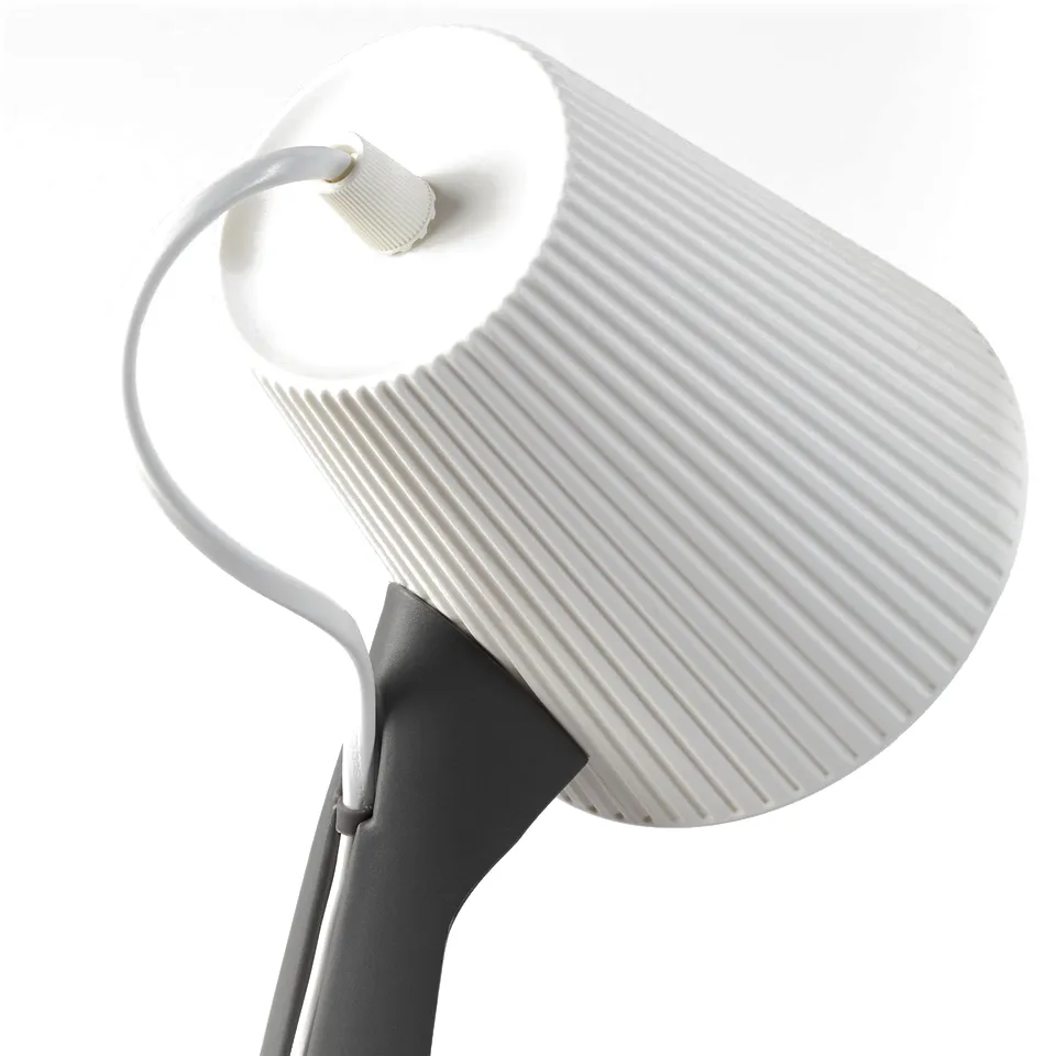 Modern white lamp with striped shade & grey base, sleek & functional design. Award-winning red dot recipient.
