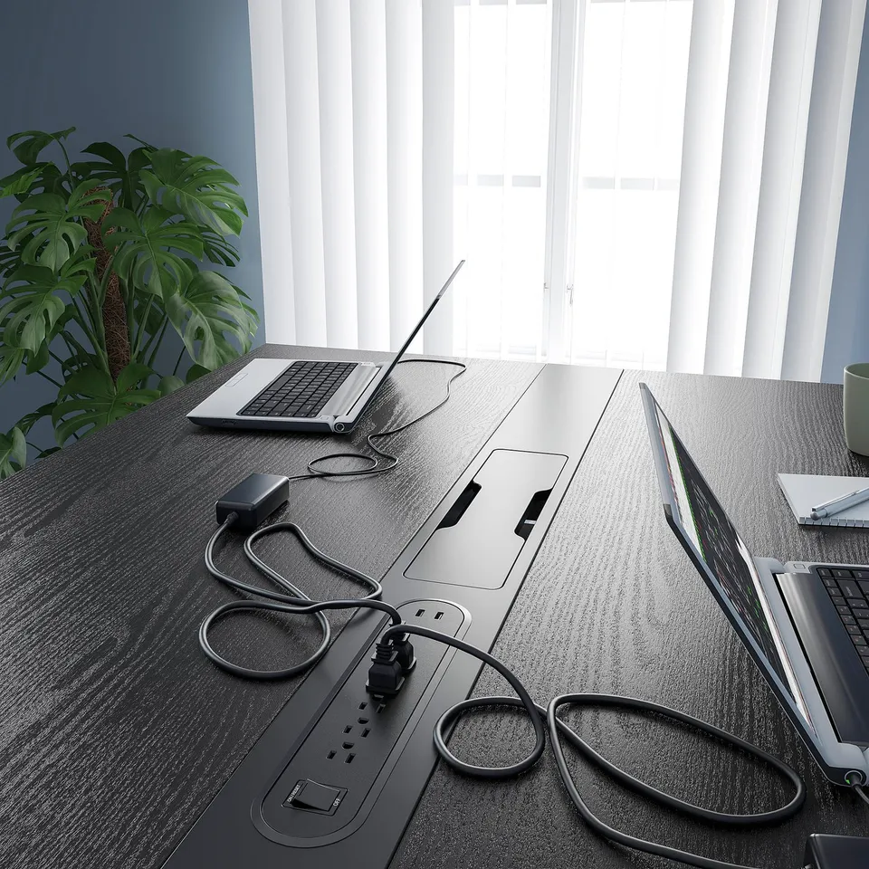 Modern high conference table with built-in power outlets and cable management, perfect for meetings and co-working spaces.
