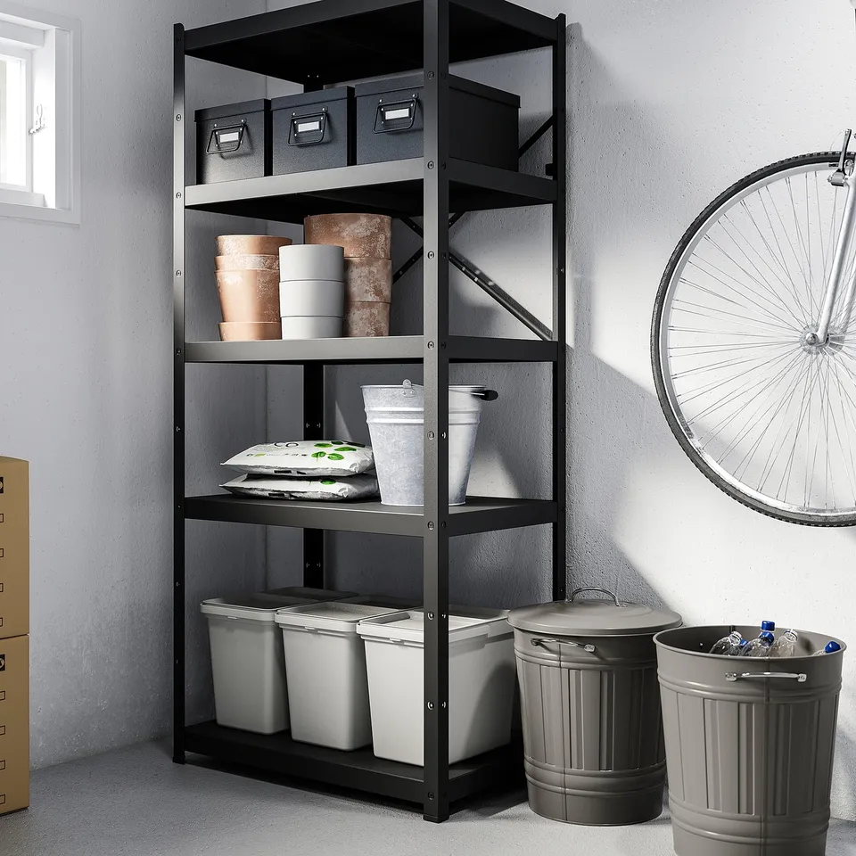 Black metal shelf with bins, buckets, boxes, and a mounted bike wheel.
