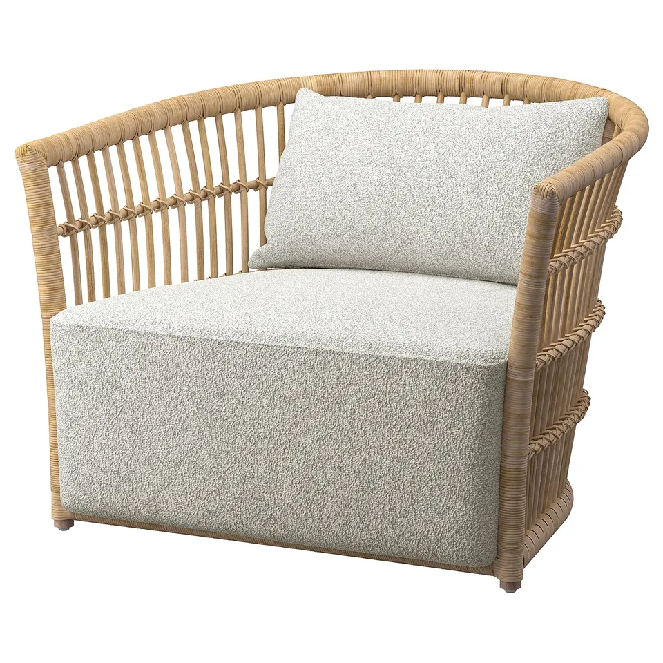 STOCKHOLM 2025: comfortable armchair with beige fabric & natural rattan frame. Soft & inviting, designed for relaxation.