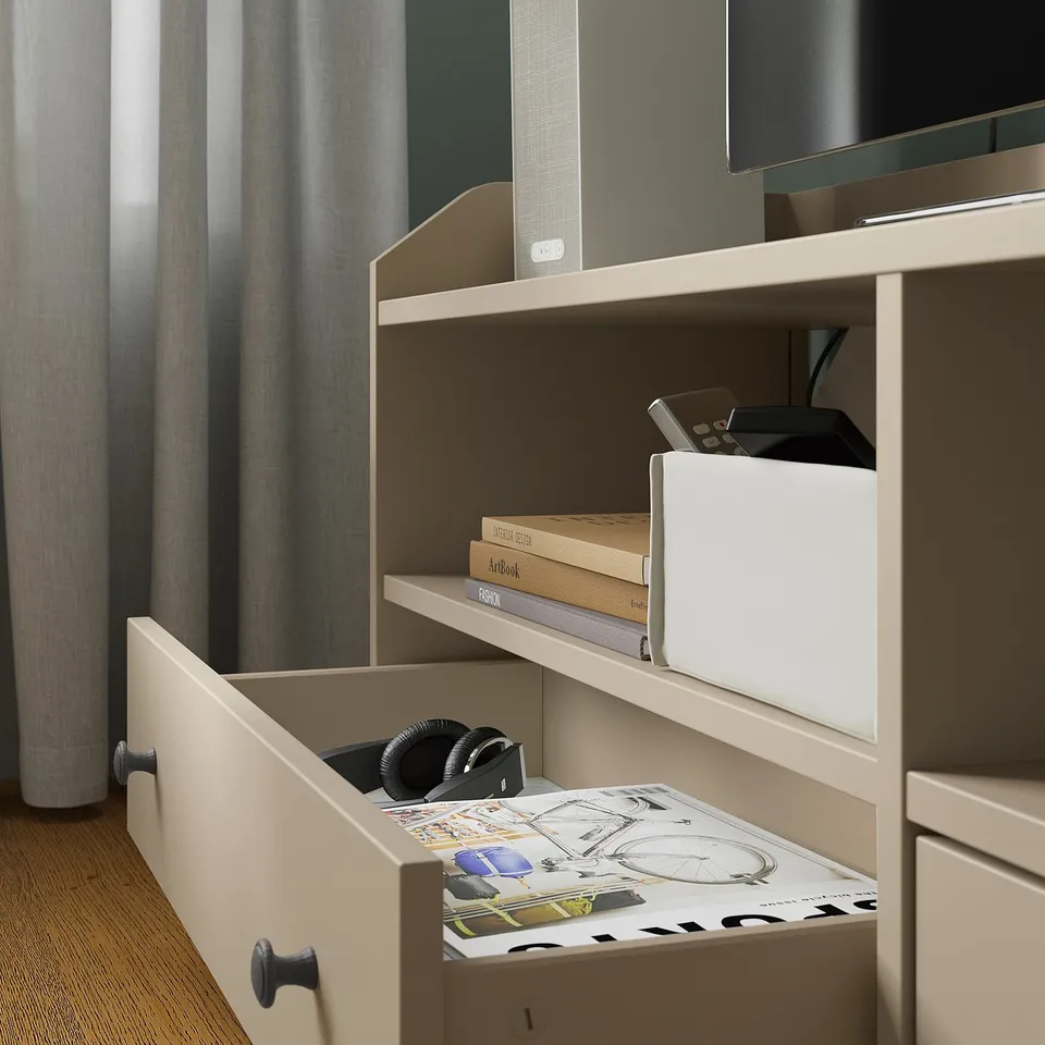 Open shelves hold books and electronics, closed drawer conceals magazines and headphones.