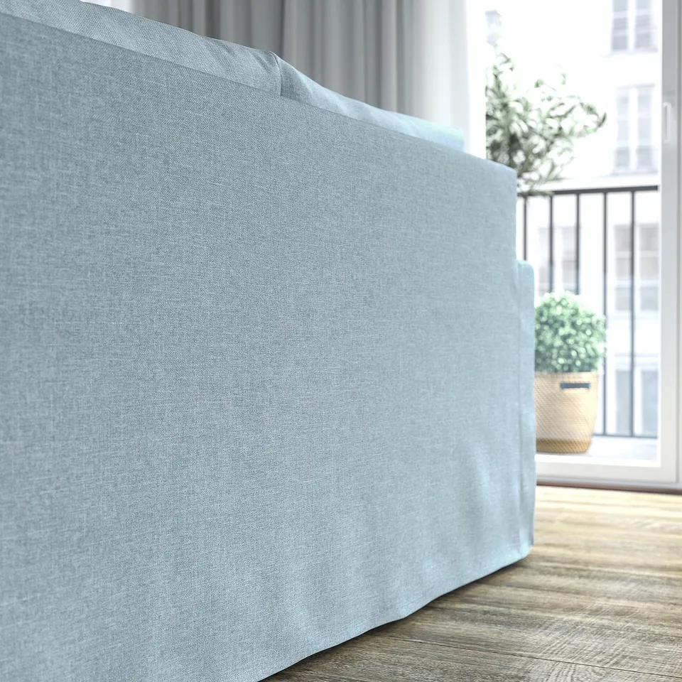 Light blue sofa with rolled back, curvy design. Cover is machine washable with a soft, melange fabric. Spacious and inviting for comfort.
