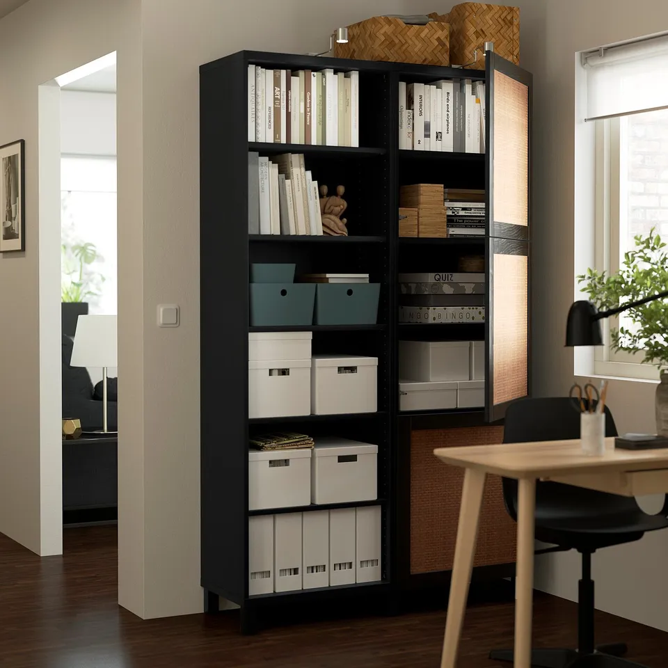 Modern home office with BESTÅ storage unit showing books, boxes, and decorative items.