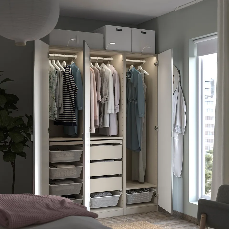 Modern bedroom with IKEA PAX wardrobe, mirrored doors, and natural light.