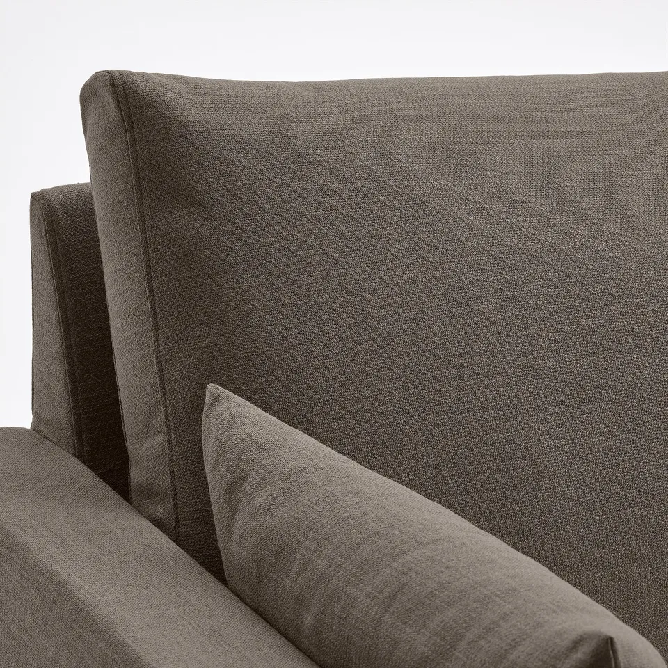 Modern sofa with sleek, dark upholstery, spotless fabric, straight lines, and sleek cushions.