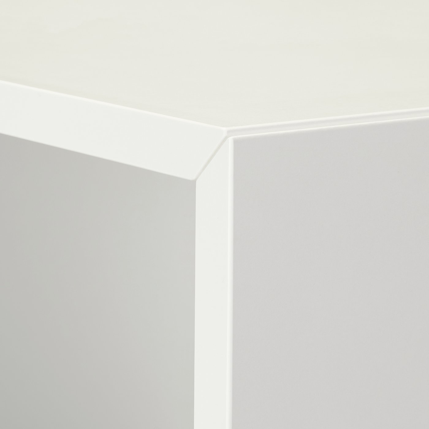 Clean white corner of sleek, modern storage unit with hidden seam.