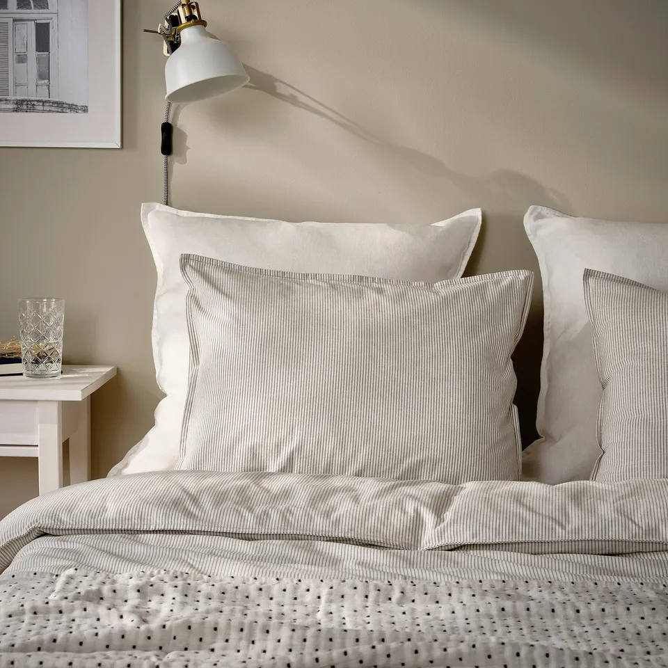 A DYTÅG white linen cushion with zip.