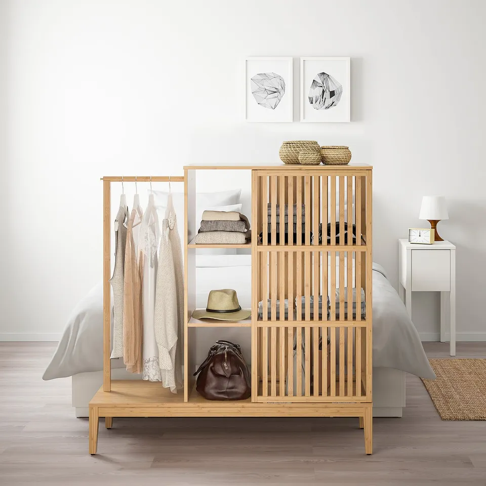 NORDKISA light wood wardrobe with clothes & accessories, blending into decor.