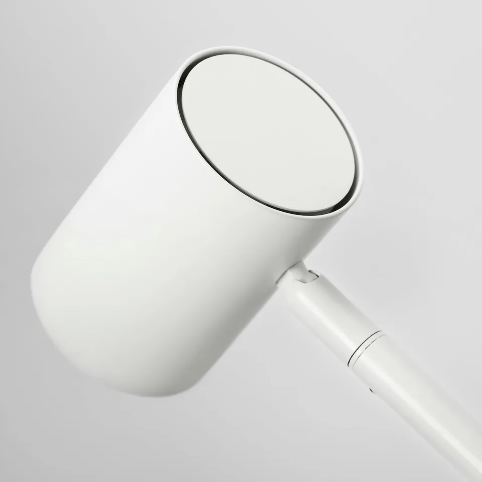Modern white lamp with adjustable neck, providing focused light.