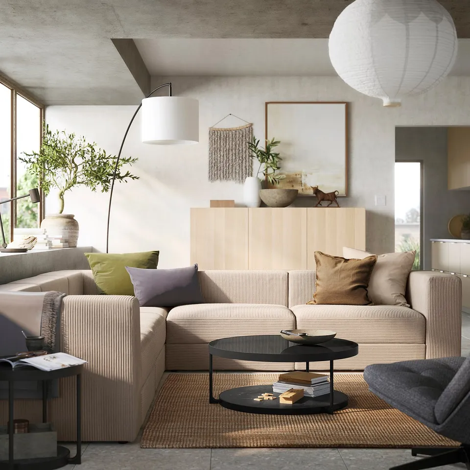 Modern living room with JÄTTEBO modular sofa in beige, featuring light wood cabinet, plants, and hanging lamps.