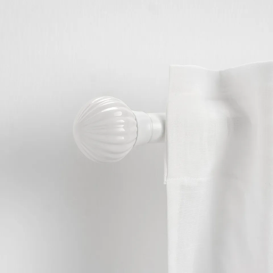 LERBRONIA white ceramic finial, small, round, simple design, attached to a larger white item.