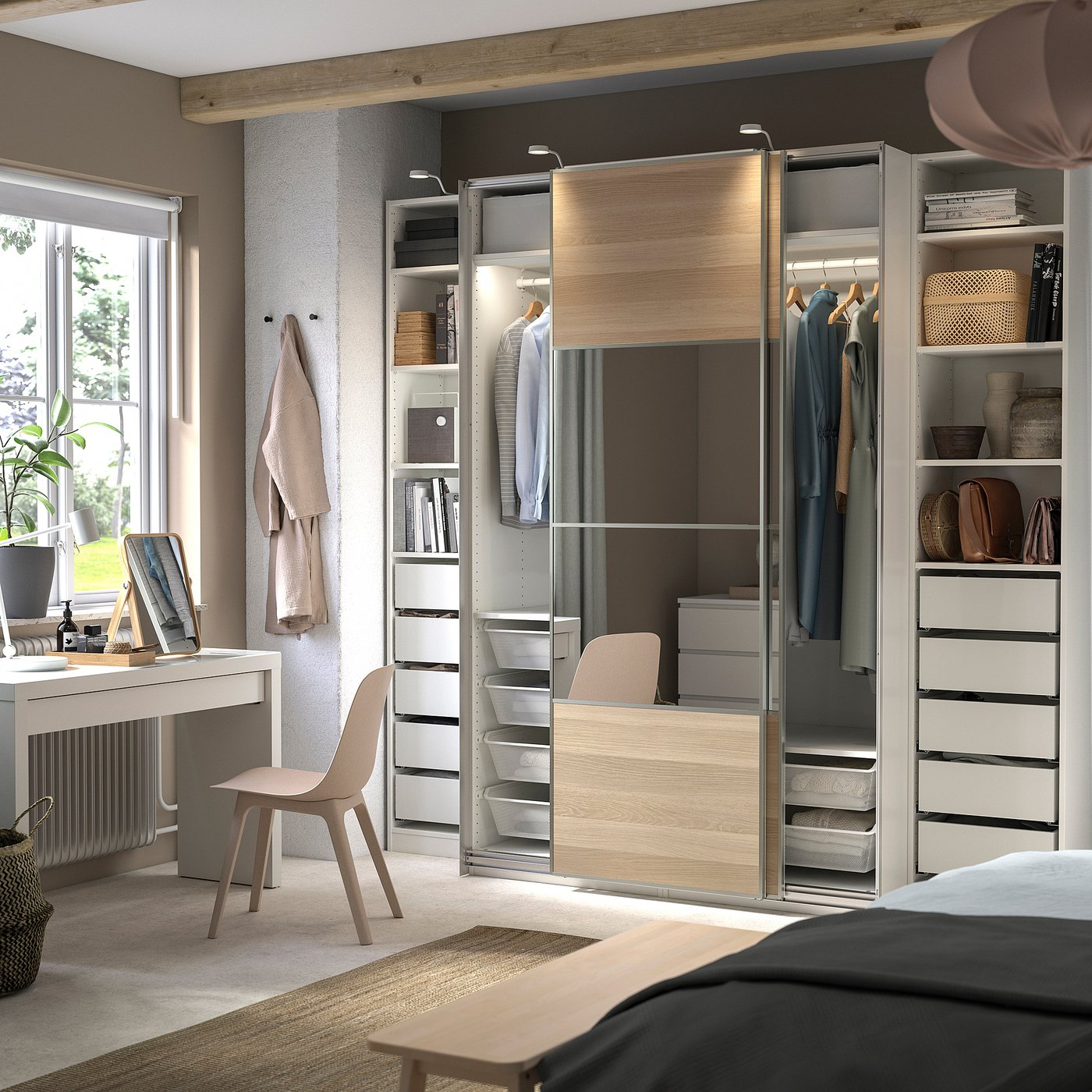 A modern bedroom a light wood and grey PAX wardrobe system, with sliding doors and built-in shelves holding clothes and decorative items.