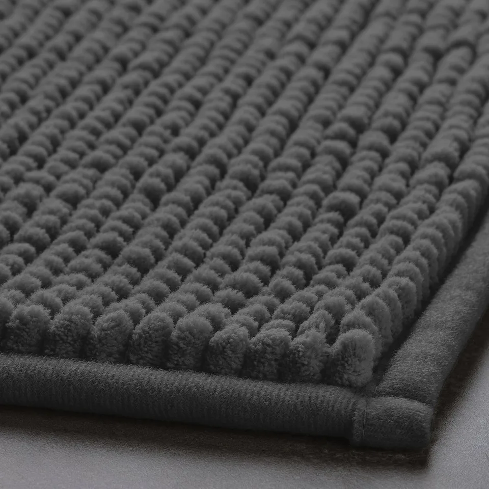 Soft, grey textured bath mat with detectable, raised dots for comfort.