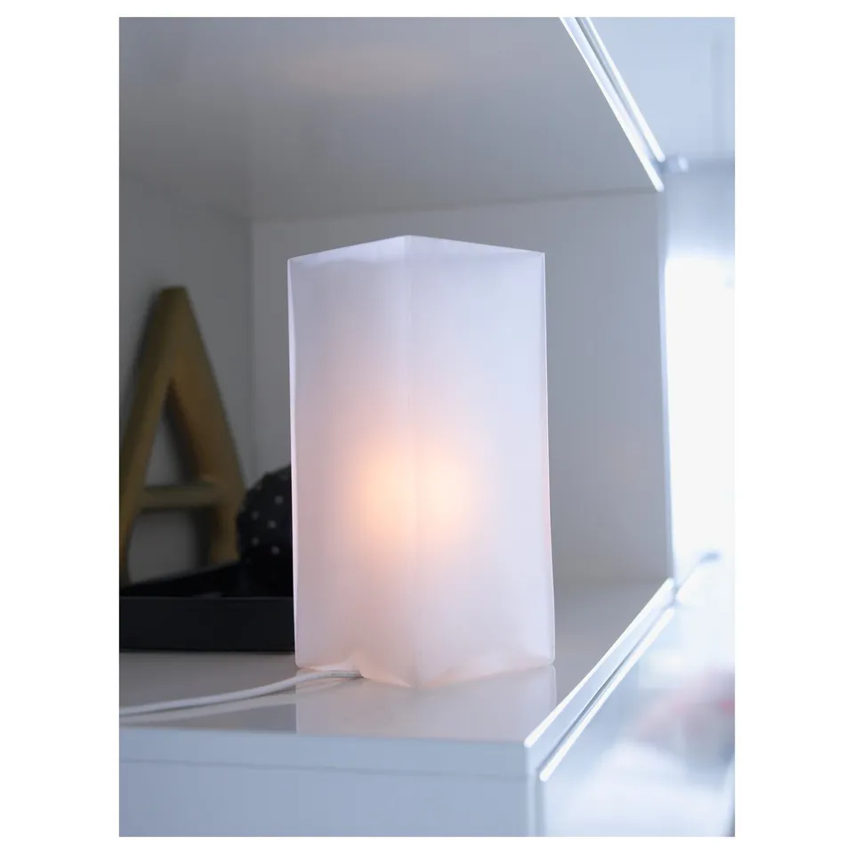 Frosted glass table lamp on a surface, providing warm, soft mood lighting. Ce certified, requires e14 led bulb.
