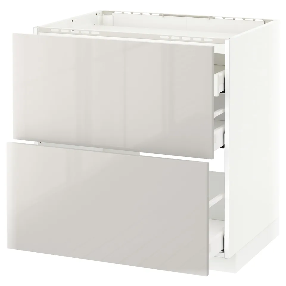 A white ikea METOD kitchen base cabinet with two drawers. It a modern, high-gloss design with smooth-running drawers.