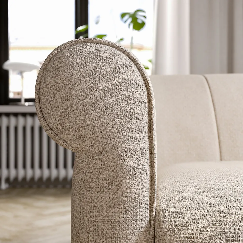 Beige VISKAFORS sofa with soft arms and label.