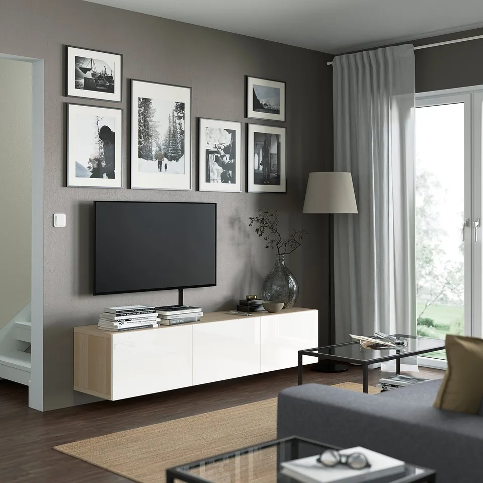 Modern living room with BESTÅ tv stand, honeycomb interior, flat-screen tv, photos, minimalist decor.