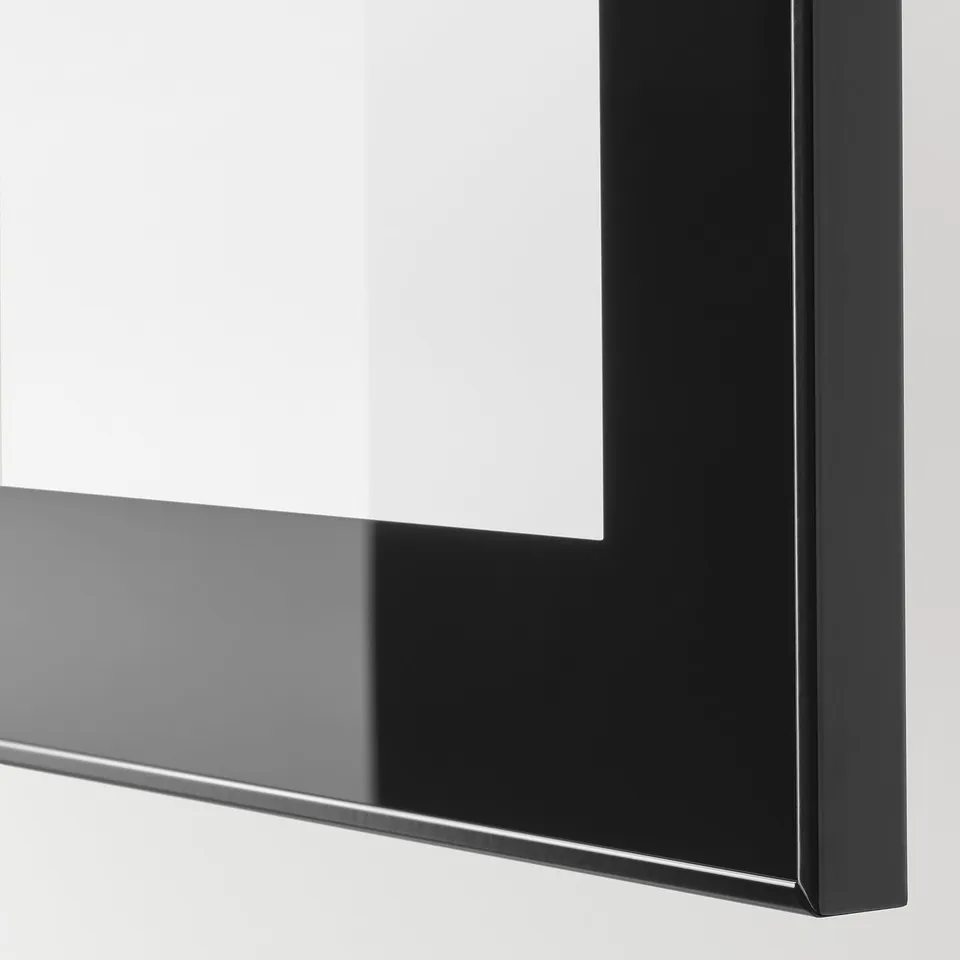 Close-up of sleek, modern tv storage unit with glossy black finish, highlighting smooth edges and reflective surface.