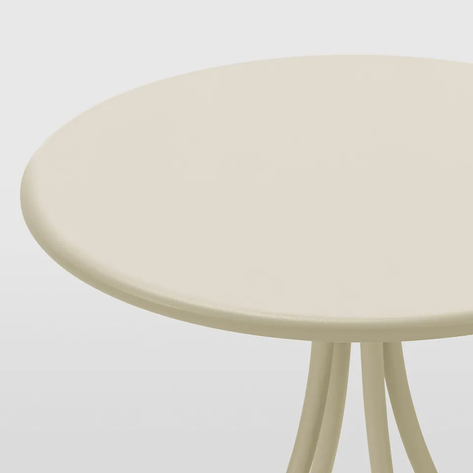 Round beige tabletop with smooth, clean edges supported by four thin, curved legs. Shows quality craftsmanship.
