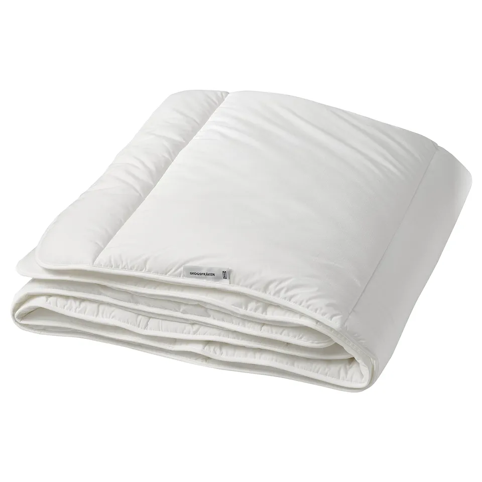 A white SKOGSFRÄKEN duvet with soft, fluffy recycled polyester and lyocell filling, ideal for extra warmth, featuring breathable fabric for comfort.