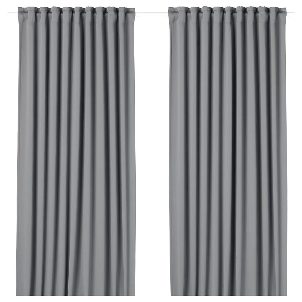 Two grey block-out curtains with rod pockets, cascade from ceiling to floor, offering privacy and light control.