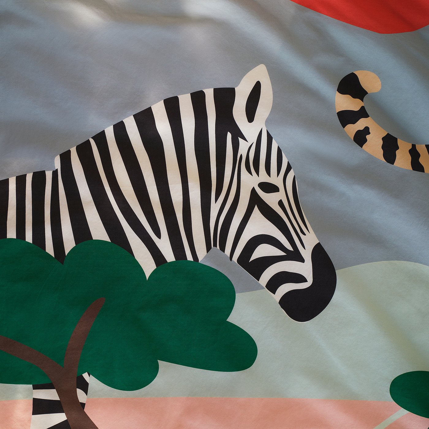 Zebra close-up, bold stripes in black and white, on soft savannah fabric, with green leaf.